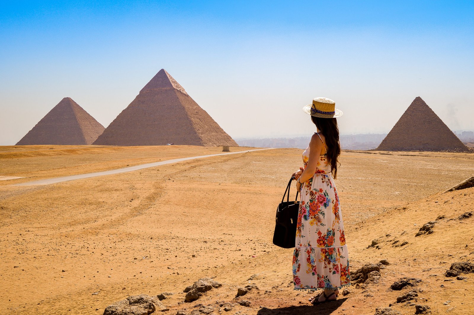 young-woman-visiting-pyramids-egypt-scaled